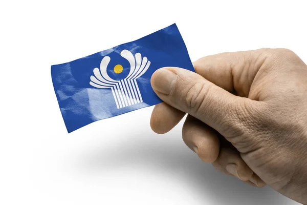 Hand holding a card with a national flag the CIS — Stock Photo, Image