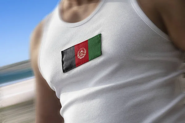 Nationell flagga Afghanistan på idrottarnas bröst — Stockfoto
