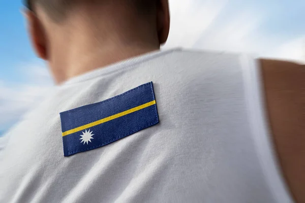The national flag of Nauru on the athletes back — Stock Photo, Image