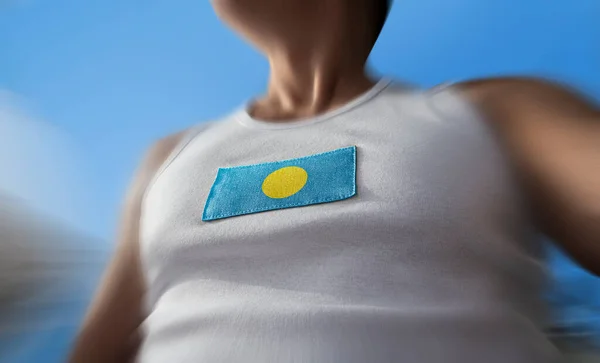 The national flag of Palau on the athletes chest — Stock Photo, Image