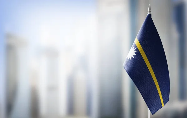 A small flag of Nauru on the background of a blurred background — Stock Photo, Image