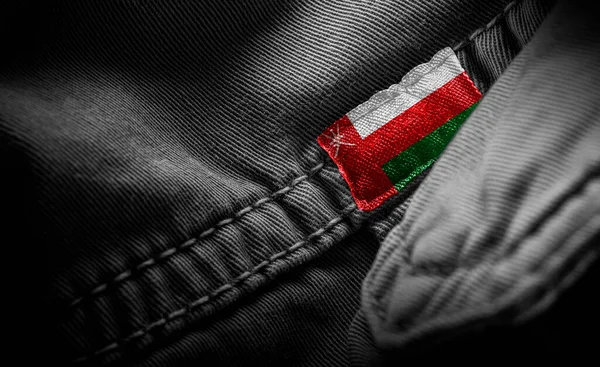 Tag on dark clothing in the form of the flag of the Oman — Stock Photo, Image