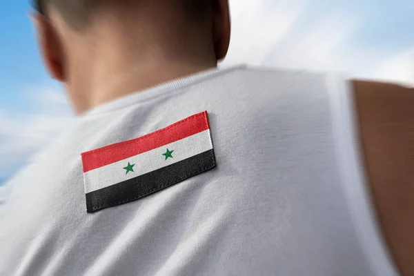 The national flag of Syria on the athletes back — Stock Photo, Image