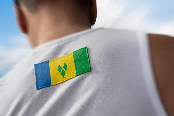 The national flag of Saint Vincent on the athletes back — Stock Photo, Image