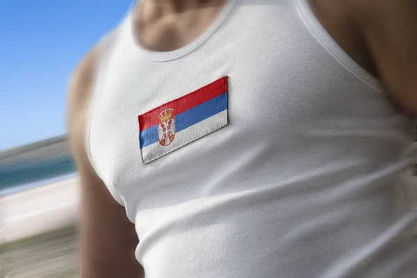 The national flag of Serbia on the athletes chest — Stock Photo, Image