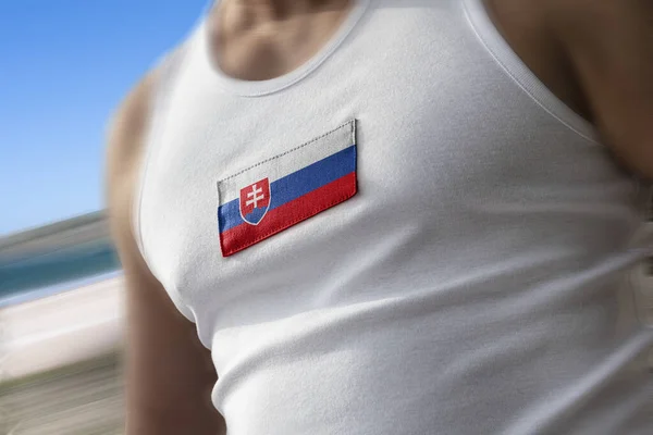 The national flag of Slovakia on the athletes chest — Stock Photo, Image
