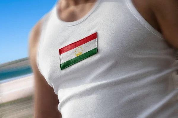 Bandeira nacional do Tajiquistão no peito dos atletas — Fotografia de Stock