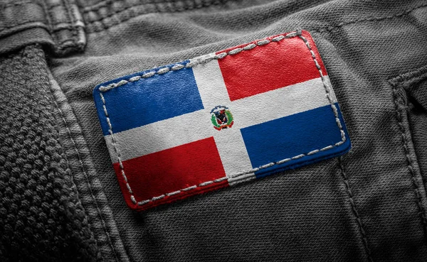 Tagg på mörka kläder i form av flagga Dominicana — Stockfoto