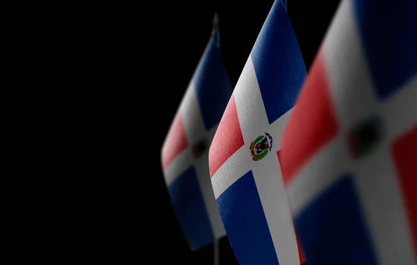 Pequeñas banderas nacionales de Dominicana sobre fondo negro — Foto de Stock