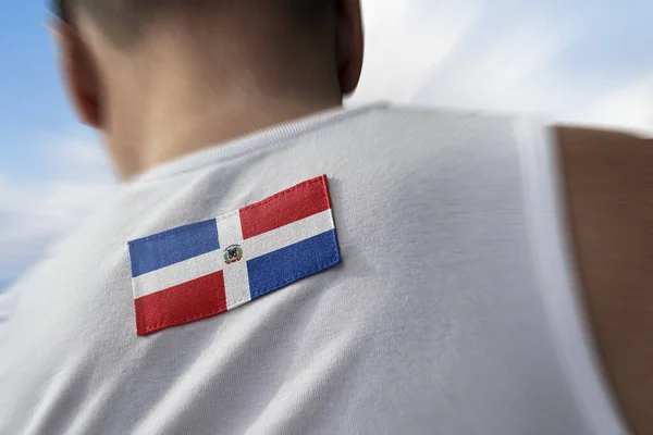 The national flag of Dominicana on the athletes back — Stock Photo, Image