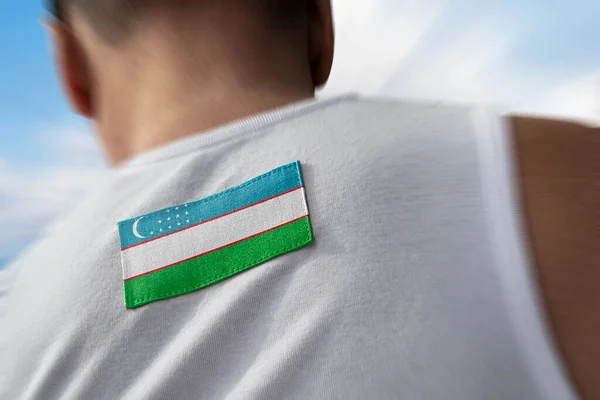Bandeira nacional do Uzbequistão nas costas dos atletas — Fotografia de Stock