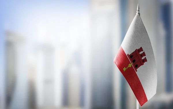 A small flag of Gibraltar on the background of a blurred background — Stock Photo, Image