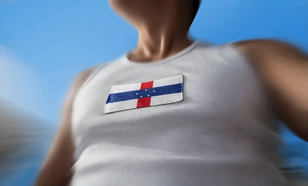 The national flag of Netherlands Antilles on the athletes chest — Stock Photo, Image