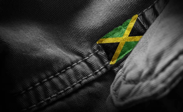 Tag on dark clothing in the form of the flag of the Jamaica — Stock Photo, Image