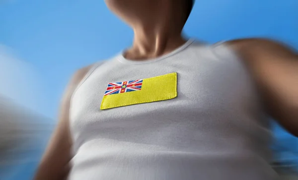 Le drapeau national de Niue sur la poitrine des athlètes — Photo