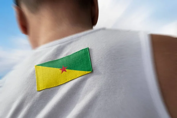 Národní vlajka Francouzské Guyany na sportovcích zpět — Stock fotografie