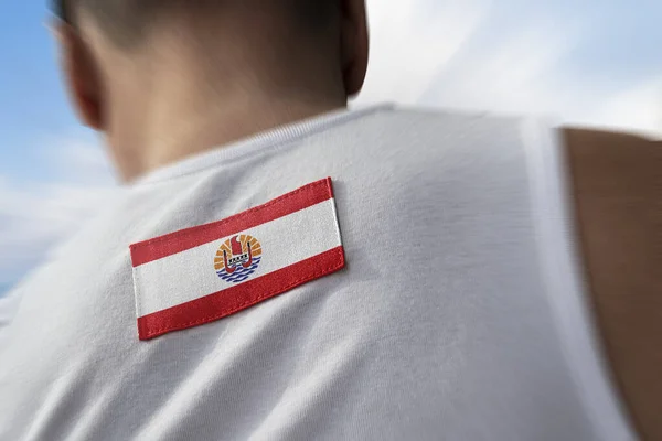 The national flag of French Polynesia on the athletes back — Stock Photo, Image