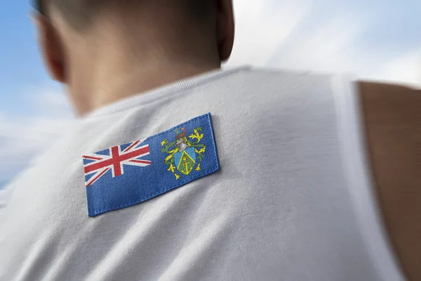 La bandera nacional de Islas Pitcairn sobre los atletas —  Fotos de Stock