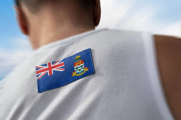 La bandera nacional de Islas Caimán en los atletas — Foto de Stock