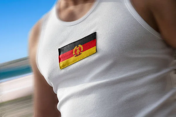 Nationell flagga DDR på idrottare bröstet — Stockfoto