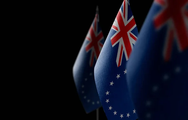 Small national flags of the Cook Islands on a black background – stockfoto