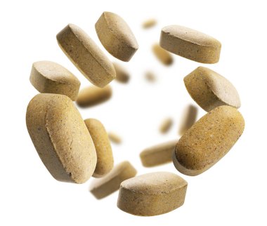 Sarı haplar beyaz arkaplanda uçar.