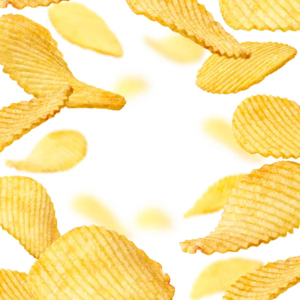 Geriffelte Kartoffelchips schweben auf weißem Hintergrund — Stockfoto