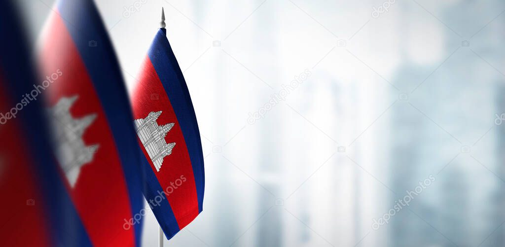Small flags of Cambodia on a blurry background of the city