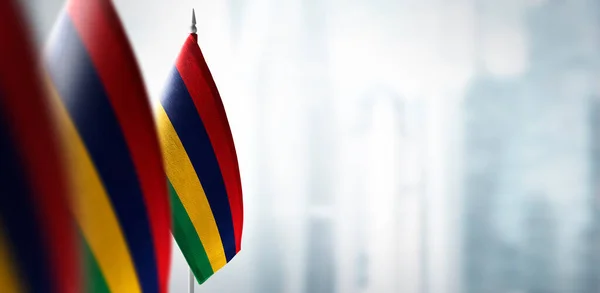 Small flags of Mauritius on a blurry background of the city — Stock Photo, Image