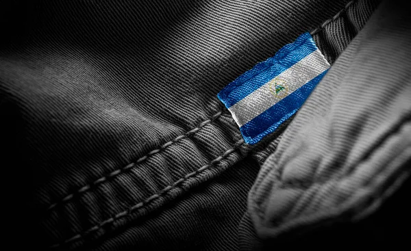 Tag on dark clothing in the form of the flag of the Nicaragua — Stock Photo, Image