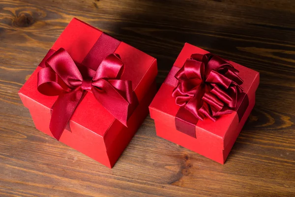 top down of festive red box with bow on wooden background is iso