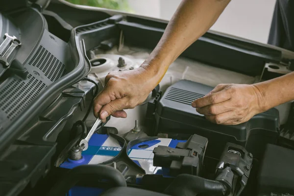 Engine engineer is replacing  car battery because car battery is depleted. concept car maintenance And the cost of car care.