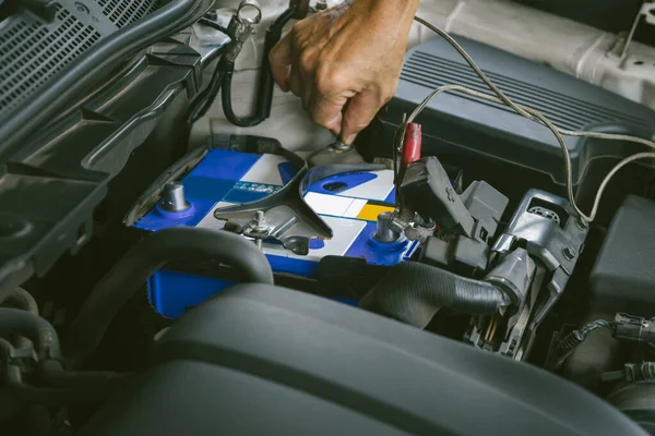 Engine engineer is replacing  car battery because car battery is depleted. concept car maintenance And the cost of car care.