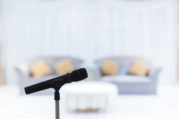 Microphone in concert hall or conference room soft and blur style for background. Microphone over the Abstract blurred photo of conference hall or seminar room background.