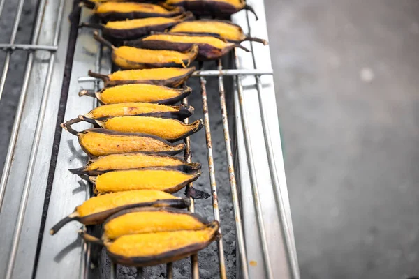 Roasted banana at street food shop, Grilled banana in Thai style Traditional, Dessert by grilling banana on the hot charcoal, Thai banana sweet dessert.