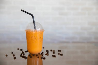 Paket servis bardağında buzlu Tayland çayı. Taze Tayland çaylı bir bardak Thai çayı. Ev yapımı sütlü buzlu latte çayı..