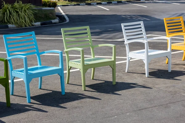 Colorful wooden chairs. A row of colorful chairs. Colorful wooden chairs on various background, can be use for background or prints.