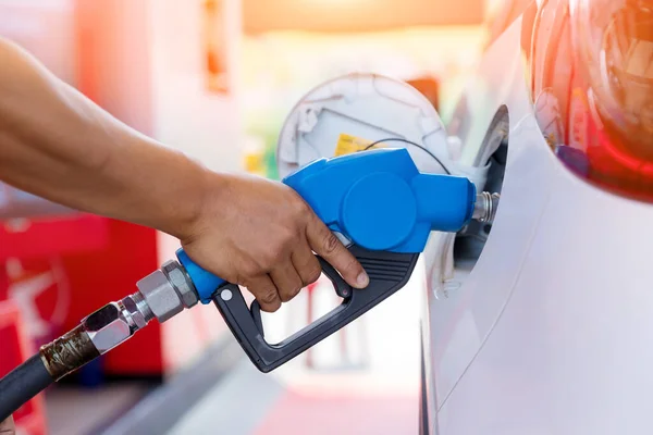 Hand Man Refill and filling Oil Gas Fuel at station. Gas station - refueling. To fill the machine with fuel. Car fill with gasoline at a gas station. Gas station pump.