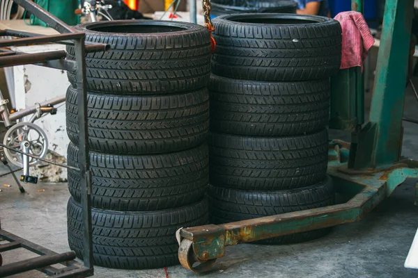 Group of new tires for race car. New tires for sale at a tire store. Car tires in the warehouse.