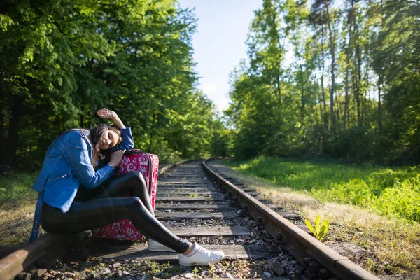 During long journeys on foot along the tracks, the teenager decided to sit down and rest directly on the railway track.
