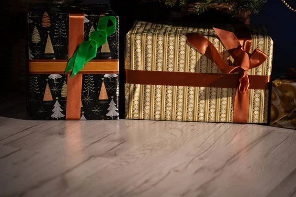 Hay muchos regalos bajo el árbol de Navidad que la familia y los amigos recibirán en Navidad. Navidad tradicional. Una sala de estar cálidamente decorada en casa. —  Fotos de Stock