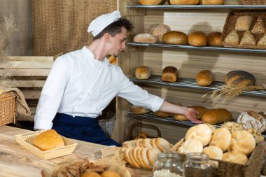 Yakışıklı bir fırıncı susamış müşterilere taze ekmek servis eder. Geleneksel bir pastanede ekmek satışı.