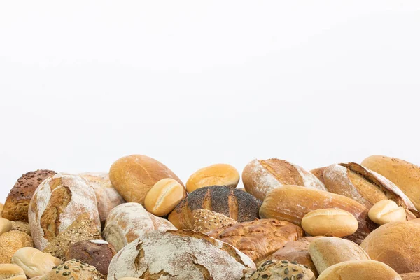 Many kinds and kinds of bread collected in one place as decoration for a traditional bakery. White background from the top for self-completion. — Stock Photo, Image