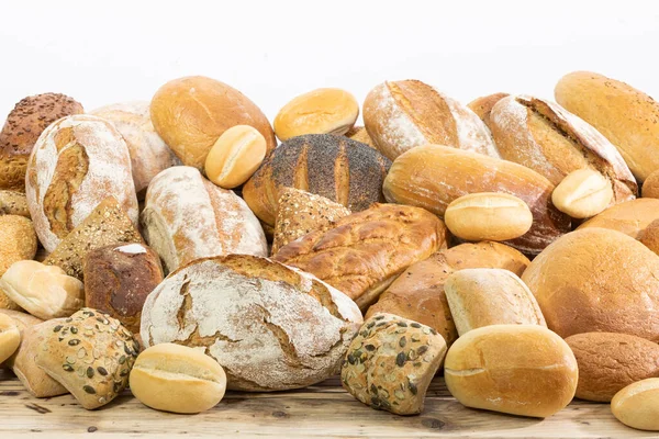 Many kinds and kinds of bread collected in one place on a wooden old shop counter as a decoration for a traditional bakery. White background from the top for self-completion. — Stock Photo, Image