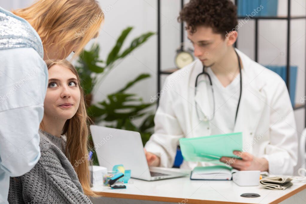 A mother explains to her daughter how she should handle what the doctor has told her about health. Doctors office