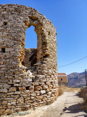 Venture into and explore the remnants of ancient historical architecture set proudly against a clear blue sky