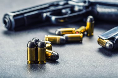 9mm pistol gun and bullets strewn on the table