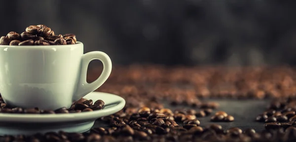 Kaffee. Kaffeebohnen. Kaffeetasse voll Kaffeebohnen vorhanden. Getöntes Image — Stockfoto