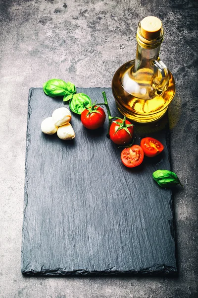 Tomatoes. Cherry tomatoes. Cocktail tomatoes. Fresh grape tomatoes carafe with olive oil on table. Toned photo — Stockfoto