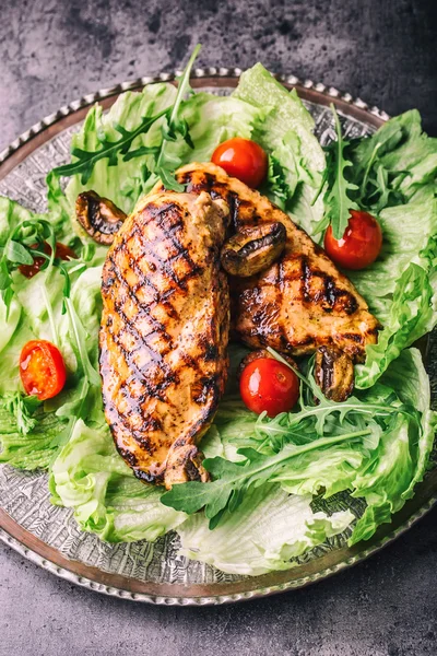 Grilled chicken breast in different variations with lettuce salad cherry tomatoes  mushrooms herbs cut lemon on a wooden board or teflon pan. Traditional cuisine. Grill kitchen — Stock Photo, Image